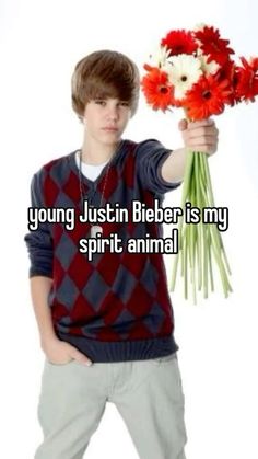 a man holding flowers with the caption young justin bieber is my spirit animal