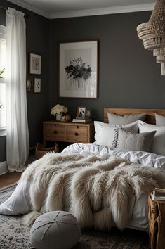 a bedroom with a large bed covered in white blankets and pillows, along with a rug on the floor