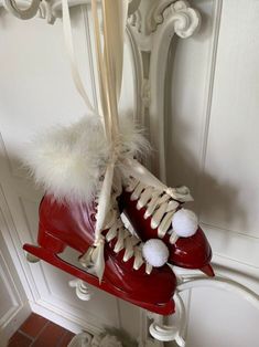 a pair of red ice skates hanging from a hook