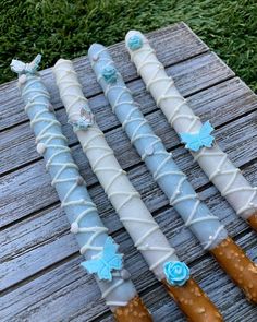 three decorated umbrellas sitting on top of a wooden table