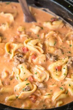 a pot filled with pasta and meat sauce