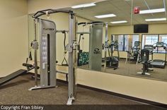 an empty gym with mirrors and exercise equipment