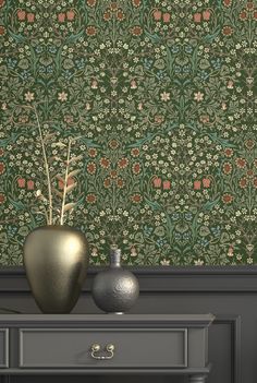 two vases on a table in front of a wallpaper