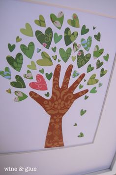 a tree with hearts painted on it in the shape of a hand