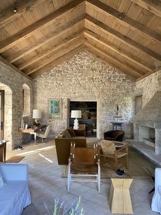 a living room filled with furniture and stone walls