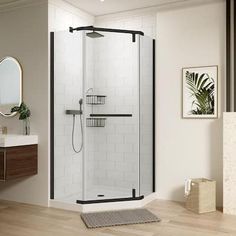 a bathroom with a walk in shower next to a white sink and wooden flooring