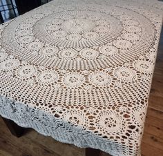 a table with a white crochet doily on it