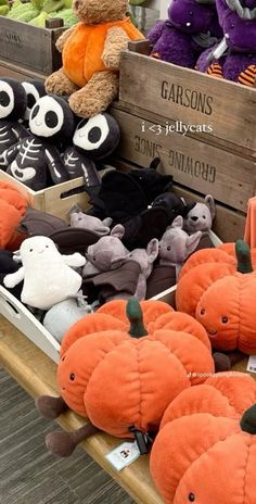 stuffed animals and pumpkins for sale at a market