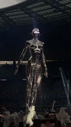 a robot standing on top of a stage in front of a crowd