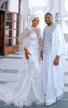 the newly married couple is posing for a photo in their white wedding gown and veil