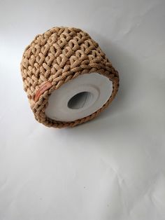 a roll of jute tape on a white surface with a hole in the middle