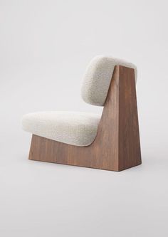 an upholstered lounge chair with a wooden base and fabric seat cushion, viewed from the front