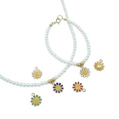 three different necklaces with flowers on them