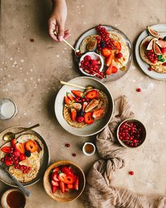 three plates of food on a table with utensils