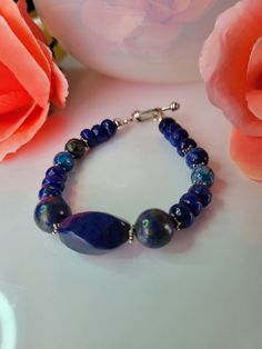 Beautiful bracelet can be wear on any occasion. Is been made with 3 Lapis lazuli stone at the center  2 10mm round 1 20x12mm swirl  4 6mm round Agate 13 6mm rondelle Agate 10 Star spacer sterling silver  1 Toggle clasp Sterling silver  This is a unique bracelet created by me. Any questions please contact me. Blue Lapis Lazuli Bracelets With Natural Stones, Blue Lapis Lazuli Gemstone Beaded Bracelet, Artisan Blue Gemstone Beads Bracelets, Artisan Blue Bracelets With Gemstone Beads, Sapphire Lapis Lazuli Beaded Bracelet With Natural Stones, Sapphire Gemstone Beads Bracelet In Lapis Lazuli, Elegant Blue Lapis Lazuli Bracelet, Polished Beads Lapis Lazuli Round Bracelets, Polished Beads Lapis Lazuli Bracelets