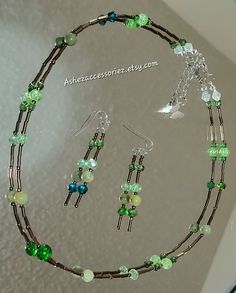 Beaded Sparkly Brown and green Necklace, (Some Green Natural Stone Beads) 17.5 Inches Long + (Extension Chain)= 19 Inches Long. & Matching Pair of Dangle Earrings Green Jade Beaded Necklaces As Gift, Green Dangle Jewelry With Colorful Beads, Green Czech Glass Necklace With Dangling Beads, Green Czech Glass Jewelry With Dangling Beads, Green Colorful Dangle Jewelry, Green Czech Glass Jewelry, Green Dangle Beaded Necklace As Gift, Green Dangle Beaded Necklace For Gift, Green Jewelry With Dangling Round Beads