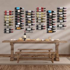 a wooden table sitting in front of a wine rack filled with bottles