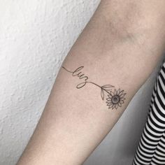 a woman's arm with a sunflower and the word love tattooed on it