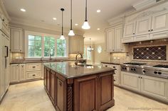 a large kitchen with an island in the middle