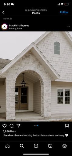 a house with white brick and arched windows