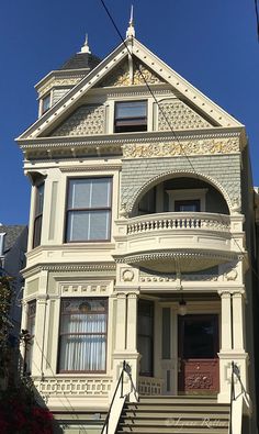 an old victorian style house with stairs leading up to the front door and second story