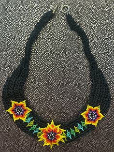 Beautiful hand made thread necklace with beaded flowers Black Crochet Bohemian Jewelry, Black Bohemian Crochet Jewelry, Adjustable Crochet Beaded Necklace For Festivals, Adjustable Crochet Flower Necklace, Handmade Black Flower Necklace, Black Flower-shaped Jewelry With Colorful Beads, Adjustable Crochet Necklaces For Festivals, Adjustable Crochet Necklace For Festivals, Bohemian Black Handwoven Beaded Necklaces