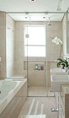 a large bathroom with two sinks and a bathtub in it's center area