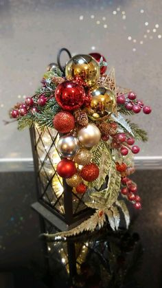 a lantern with ornaments on it sitting on a table