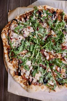 a pizza sitting on top of a wooden table