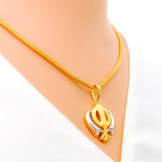 This tasteful Khanda pendant, made from 22k gold and weighing 3.8 grams, showcases an elegant dual-tone design with a primary yellow gold finish. Measuring 1.25 inches in length, it represents a blend of spiritual significance and contemporary style, embodying the essence of Sikh courage and remembrance. Ideal for those who appreciate symbolic jewelry with modern aesthetics, this dual-tone Khanda pendant is a meaningful addition to any collection, offering a touch of grace and tradition. PRODUCT DETAILS Gold Purity(karat): 22k Gold Weight(grams): 3.8 Item Finish: Yellow Gold Pendant Length: 1.25" Chain: Not Included Dual-tone Gold Temple Necklace As Gift, Dual-tone Pendant Temple Necklace For Gifting, Dual-tone Pendant Temple Necklace As Gift, Dual-tone Yellow Gold Temple Jewelry Necklace, Gold Dual-tone Temple Necklace For Puja, Dual-tone Gold Temple Necklace For Diwali, Gold Dual-tone Temple Necklace For Diwali, Yellow Gold Dual-tone Temple Jewelry Necklaces, Yellow Gold Dual-tone Temple Jewelry Necklace