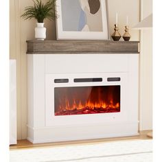 a white fireplace with an electric fire in the center and a framed photograph on top