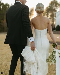 the bride and groom are holding hands