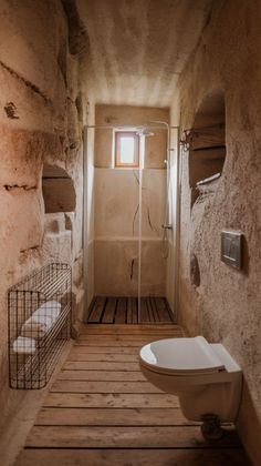 a bathroom with a toilet, sink and shower stall in the wall next to each other