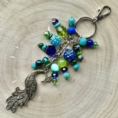 a close up of a keychain with beads and charms on it's side