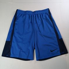 Elevate Your Activewear Game With These Nike Shorts For Men. The Solid Blue Color Is Perfect For Any Occasion, Whether It's For Travel, Work Or Casual Wear. The Drawstring Closure And Adjustable Waist Provide Maximum Comfort And The 100% Polyester Material Ensures That It's Machine Washable And Easy To Care For. These Athletic Shorts Come With Pockets And Have A 9-Inch Inseam, Making It Perfect For Gym And Cross-Training, Basketball As Well As Running And Jogging During The Summer, Fall, And Spr Nike Blue Athletic Shorts With Built-in Shorts, Sporty Blue Short Pants, Blue Nike Athletic Shorts With Elastic Waistband, Training Basketball, Travel Work, Red Nike, Active Wear Shorts, Shorts For Men, Basketball Shorts