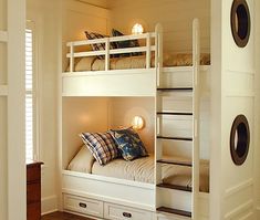 a bunk bed with two sets of drawers underneath it in a room that has white walls and wood floors