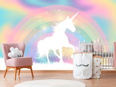 a baby's room with a unicorn wall mural