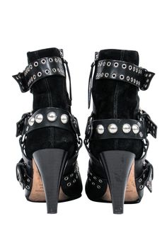 Unleash your inner rocker chick in these over-the-top booties from Isabel Marant. Buckles with grommets and studs adorn these edgy boots. Perfect for your next concert! Pair with distressed jeans and a leather jacket and you'll be sure to be invited on stage! Size 5.5 (FR 37) Leather upper w/ suede trim Buckled design w/ grommets and studs Interior side zipper closure Pointed toe Chunky heel Leather sole and footbed w/ very minor wear Heel 3.5" Punk Moto Boots With Rivets And Pointed Toe, Edgy Moto Boots With Studs And Pointed Toe, Edgy Studded Moto Boots With Pointed Toe, Rocker Style Moto Boots For Parties, Studded Boots For Concerts In Fall, Punk Style Studded Moto Boots For Party, Punk Studs Heeled Boots For Fall, Punk Stud Heeled Boots For Fall, Punk Style Studded Heeled Boots For Fall