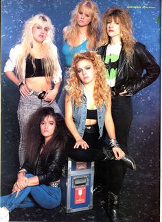 the runaways posing for a photo in their 80s's style outfits and jeans