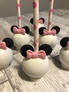 mickey mouse cake pops with pink bows on them