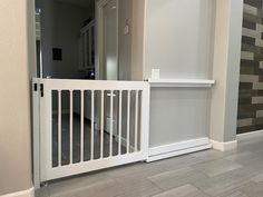 an empty room with white railings and wood flooring on the side of it