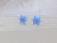 "This earrings are made of Opal and 925 Sterling Silver. Stone: Lab Opal Colors: White, Light Blue ans Blue Star size: 6 mm Beautiful present for a loved one or for yourself. Our Jewelry is packaged in a beautiful gift box POLICIES PAYMENT We accept Pay Pal only. You DON'T need a PayPal account to pay for your items. Just choose the PayPal option during checkout, submit your order and \"PAY NOW\", scroll down and choose the option \"Credit or Debit Card\". SHIPPING Shipping is via Eco Post expre Celestial White Opal Jewelry, Blue Sterling Silver Star Earrings, Hypoallergenic Blue Star Earrings, Star-shaped Opal Jewelry Gift, Blue Star-shaped Sterling Silver Earrings, Hamsa Ring, Nickel-free Blue Opal Jewelry, David Star, Blue Opal Nickel-free Jewelry