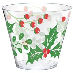 a glass with holly and berries on it