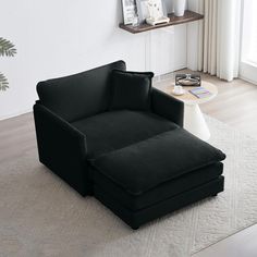 a black couch sitting on top of a white rug