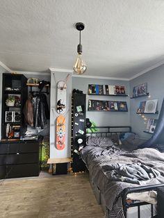 a bedroom with a skateboard on the wall next to a bed and dressers