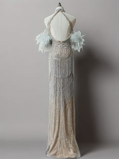 the back of a dress with feathers on it