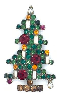 Vintage Weiss Six 6 Candle Vintage Christmas Tree Pin Brooch is the king of all vintage Christmas tree pins IMHO! Pictured on Page 79 of Mary Morrison's, Christmas Jewelry, it combines frosted baguette candles with large red round rhinestone ornaments on a tree of emerald green rhinestones with a pear-shaped clear rhinestone "treetop star" and a topaz rhinestone base with one pear-shaped clear rhinestone at the bottom right of the tree and two fuchsia and six golden citrine rhinestone smaller ornaments. The tree measures approximately 2-3/4 x 1-5/8" and has a safety closure. It is signed "Weiss" with a copyright symbol on an oval signature plaque applied sideways along the base of the trunk on the reverse of the pin. In Very Good/Excellent Condition, we guarantee this pin to be an authenti Candle Christmas Tree, Candle Pins, Rhinestone Ornaments, Tree Candle, Christmas Tree Candles, Candle Tree, Pink Candles, Large Candles, Christmas Pins