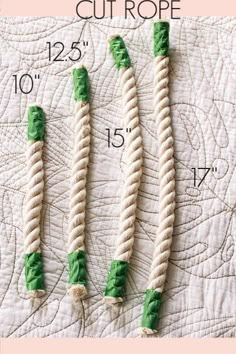 four green and white rope on top of a quilted surface with measurements for each piece