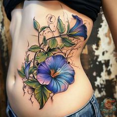 a woman's stomach with blue flowers on it