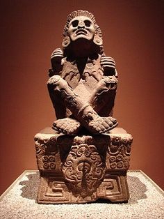 a stone statue sitting on top of a table